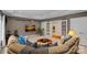 Spacious living room featuring a comfortable sofa, tv, and walk out patio doors at 1305 Anniston Pl, Wesley Chapel, NC 28079