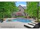 Backyard pool and patio with waterfall feature and a spacious lawn, perfect for entertaining at 1305 Anniston Pl, Wesley Chapel, NC 28079