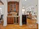 A home wet bar with dark wood cabinets, granite countertops and wine storage at 1305 Anniston Pl, Wesley Chapel, NC 28079