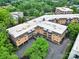 Aerial view of the multi story brick building with trees and a parking lot at 1323 Queens Rd # 420, Charlotte, NC 28207