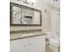Cozy bathroom featuring granite countertops, a decorative mirror, and a shower-tub combo, blending style and functionality at 1323 Queens Rd # 420, Charlotte, NC 28207