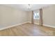 Bright bedroom featuring a window with curtains, and light wood floors at 1323 Queens Rd # 420, Charlotte, NC 28207