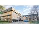 Brick condo building featuring covered parking, balconies, and manicured landscaping at 1323 Queens Rd # 420, Charlotte, NC 28207