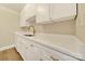 Bright galley kitchen featuring white cabinets, modern gold hardware, and new countertops, providing a clean, stylish space at 1323 Queens Rd # 420, Charlotte, NC 28207