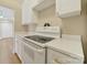 Bright galley kitchen featuring white cabinets, new countertops and updated appliances, providing a clean, stylish space at 1323 Queens Rd # 420, Charlotte, NC 28207