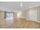 Spacious living room with modern lighting, balcony, and neutral tones, perfect for relaxation and entertaining at 1323 Queens Rd # 420, Charlotte, NC 28207