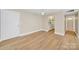 Inviting living space with light wood flooring, neutral walls, and an open kitchen at 1323 Queens Rd # 420, Charlotte, NC 28207
