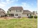 Large backyard featuring a stone patio, well-maintained lawn, and exterior of the home at 140 Halifax Dr, Fort Mill, SC 29707