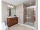 Bathroom with a walk-in glass shower and a vanity with cherry cabinet and a large mirror at 140 Halifax Dr, Fort Mill, SC 29707
