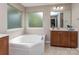 Bathroom with a large soaking tub, vanity, large mirror and frosted window for natural light at 140 Halifax Dr, Fort Mill, SC 29707