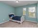 Bedroom featuring a bed with blue bedspread, neutral carpeting and two windows for natural light at 140 Halifax Dr, Fort Mill, SC 29707