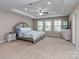 Main bedroom featuring large windows for natural light, a trey ceiling, a bed and bedside tables at 140 Halifax Dr, Fort Mill, SC 29707