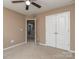 Bedroom featuring a closet and an doorway to other rooms, neutral colored carpet and walls at 140 Halifax Dr, Fort Mill, SC 29707