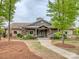 Community clubhouse with stone and siding exterior, lush landscaping, and a welcoming entrance at 140 Halifax Dr, Fort Mill, SC 29707