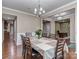 Elegant dining room featuring hardwood floors, a chandelier, and access to an office at 140 Halifax Dr, Fort Mill, SC 29707