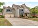 Charming two-story home showcasing a two-car garage, manicured lawn, and attractive architectural details at 140 Halifax Dr, Fort Mill, SC 29707