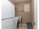 Functional laundry room with white washer and dryer, storage shelves, and natural light at 140 Halifax Dr, Fort Mill, SC 29707