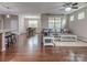 Open-concept living area with hardwood floors, a ceiling fan, and access to the dining room at 140 Halifax Dr, Fort Mill, SC 29707