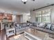Spacious living area with hardwood floors, a large couch, and access to the kitchen at 140 Halifax Dr, Fort Mill, SC 29707