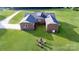 An aerial view shows the brick home with a spacious backyard with a fire pit and lots of seating at 1488 Ernest Rd, York, SC 29745