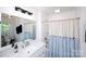 Bright bathroom with a large mirror, white vanity, and a shower with stylish curtain at 1488 Ernest Rd, York, SC 29745
