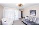 A cozy bedroom features a daybed with a decorative fan light, plush chair, and neutral wall paint at 1488 Ernest Rd, York, SC 29745
