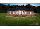 Charming brick ranch home with a cozy front porch, rocking chairs, and landscaped yard at 1488 Ernest Rd, York, SC 29745