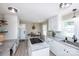 Well-lit kitchen with white cabinets, granite counters, island with cooktop, and adjacent dining area at 1488 Ernest Rd, York, SC 29745