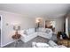 Cozy living room featuring a white sofa, patterned armchair, and view into the dining area at 1488 Ernest Rd, York, SC 29745