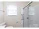 Well-lit bathroom featuring a glass enclosed shower with accessibility features at 166 Still Ave, Fort Mill, SC 29715