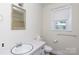 Neutral bathroom with marble countertop, framed mirror and natural light at 166 Still Ave, Fort Mill, SC 29715