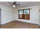 Cozy bedroom with wood-look floors, ceiling fan, and a window framed by wood and wood shutters at 166 Still Ave, Fort Mill, SC 29715