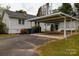 A spacious carport attached to the house with adjacent outdoor storage at 166 Still Ave, Fort Mill, SC 29715