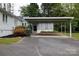 A spacious carport attached to the house with adjacent outdoor storage at 166 Still Ave, Fort Mill, SC 29715