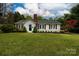 Charming single-story home with a brick chimney, well-manicured lawn, and beautiful landscaping at 166 Still Ave, Fort Mill, SC 29715