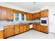 Kitchen with wooden cabinets, laminate countertops, and a white door at 166 Still Ave, Fort Mill, SC 29715
