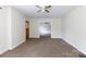Inviting living room with neutral walls, carpet flooring, and a view into another room at 166 Still Ave, Fort Mill, SC 29715