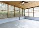 Spacious screened-in porch with exposed ceiling, lattice walls, and lights at 166 Still Ave, Fort Mill, SC 29715