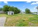 Spacious backyard featuring a storage shed, chain-link fence, and ample green space at 18 Douglas Nw Ave, Concord, NC 28025