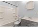 Bright bathroom featuring a shower-tub, vanity with storage, and neutral color palette at 18 Douglas Nw Ave, Concord, NC 28025