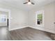 Cozy bedroom featuring neutral walls and vinyl floors, plus a bright window at 18 Douglas Nw Ave, Concord, NC 28025
