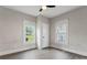 Bedroom with neutral walls, updated ceiling fan, and two bright windows at 18 Douglas Nw Ave, Concord, NC 28025