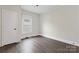Clean and bright bedroom with gray vinyl floors and white trim, plus closet door at 18 Douglas Nw Ave, Concord, NC 28025