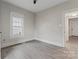 Bedroom with neutral walls, ceiling fan, light colored hardwood floors and a bright window at 18 Douglas Nw Ave, Concord, NC 28025
