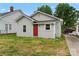 Rear of the property shows the gray siding, red door, and a driveway leading to the back at 18 Douglas Nw Ave, Concord, NC 28025