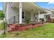 Inviting front porch with a porch swing, and classic architectural details at 18 Douglas Nw Ave, Concord, NC 28025