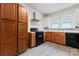 Kitchen featuring wood cabinets, stainless steel range hood and black oven at 18 Douglas Nw Ave, Concord, NC 28025