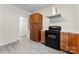 Kitchen featuring wood cabinets, stainless steel range hood and black oven at 18 Douglas Nw Ave, Concord, NC 28025