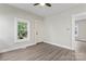 Light-filled living area with vinyl floors and multiple windows, plus white trim at 18 Douglas Nw Ave, Concord, NC 28025