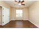 Bright bedroom features a ceiling fan, window, and beautiful hardwood floors at 18711 Ruffner Dr # 1A, Cornelius, NC 28031